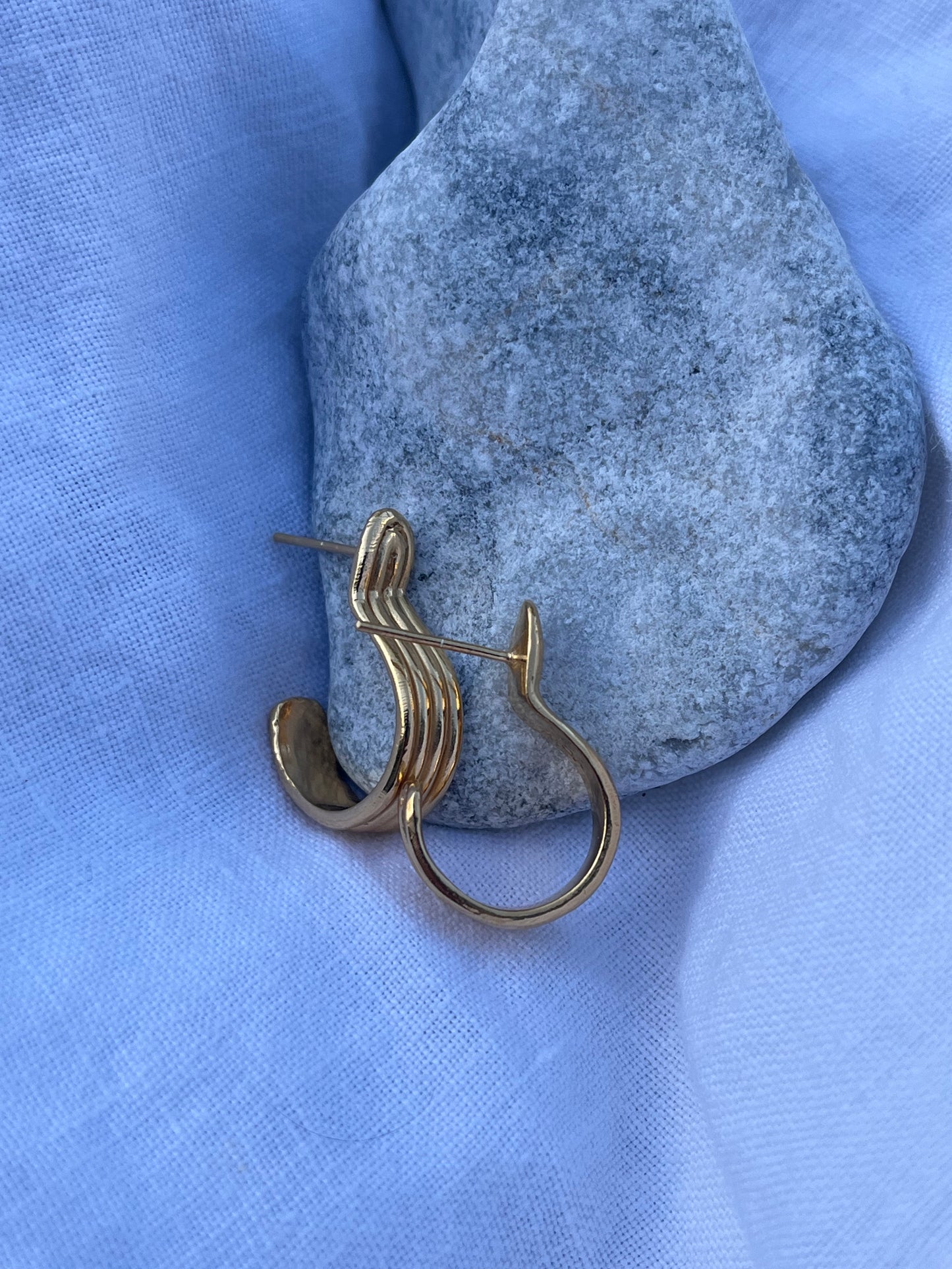 Gold hoop earrings with carved grooves and post backs
